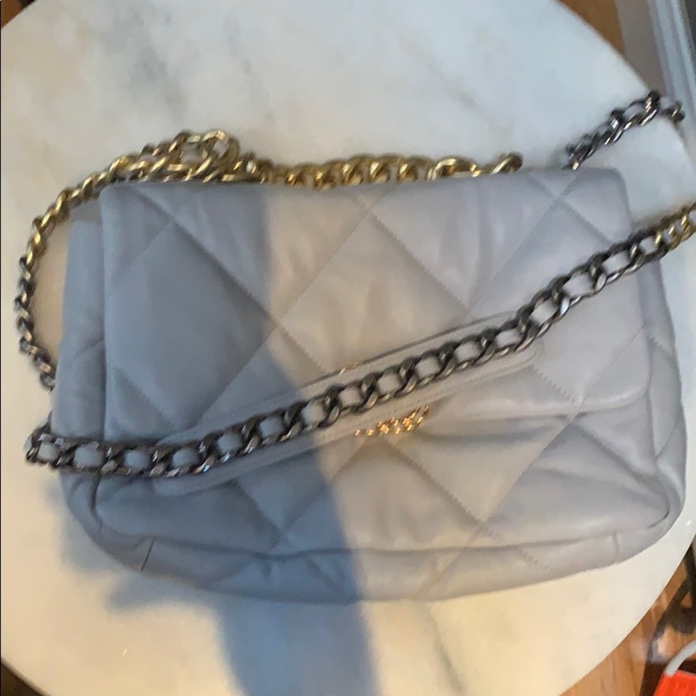 Gray quilted bag with gold and silver hardware